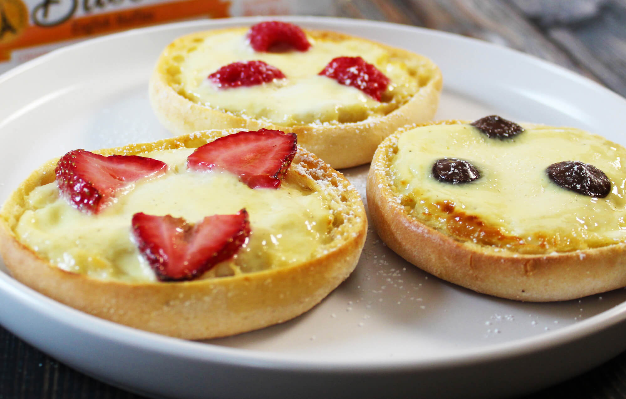 THREE BAYS TOPPED WITH STRAWBERRIES BLUEBERRIES AND PUDDING