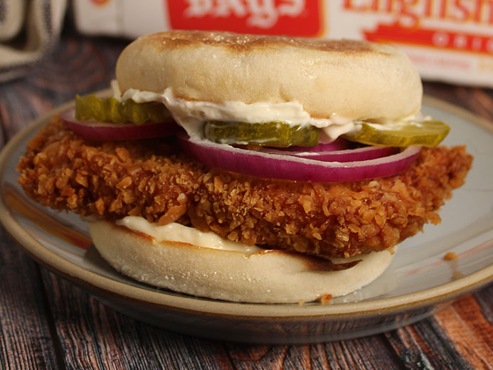 SANDWICH WITH A LARGE SLAB OF MEAT PLUS PICKLES AND ONIONS