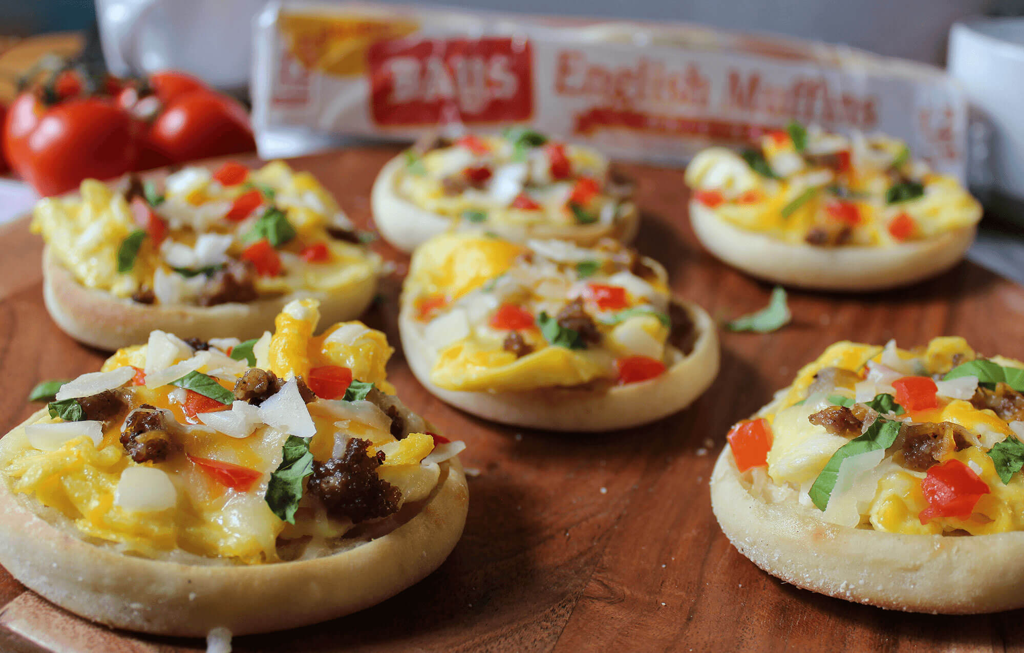 a tray of bays topped with chunks of egg pepper and sausage