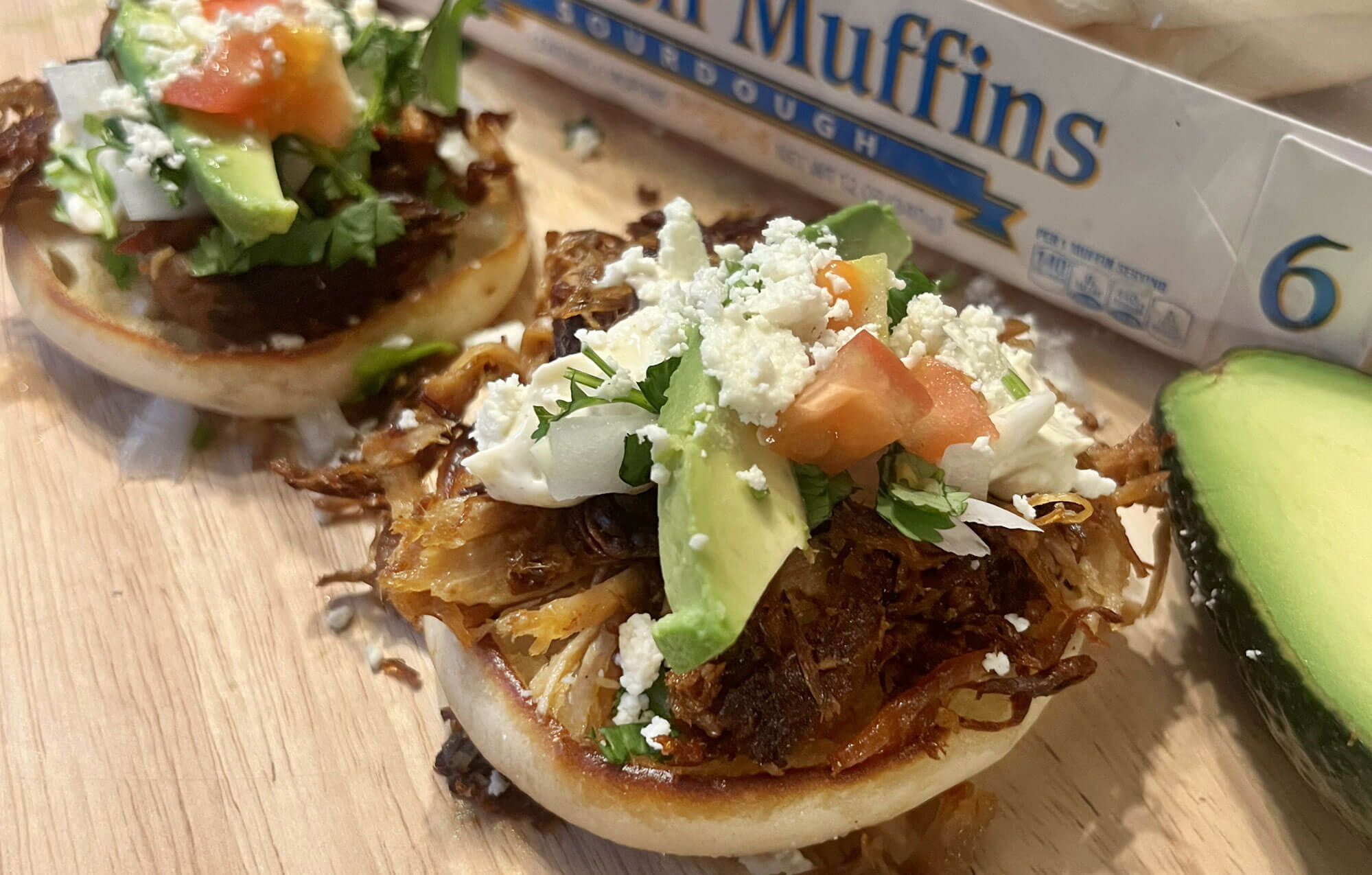 bays with meat avocado slices and crumbly cheese on top