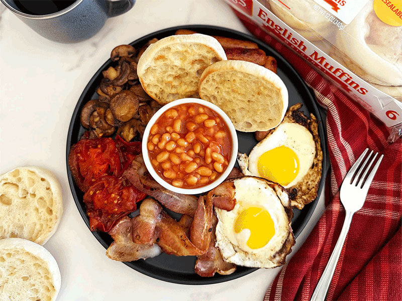 BAYS ON A TRAY WITH BEANS TOMATO EGGS BACON AND MUSHROOMS