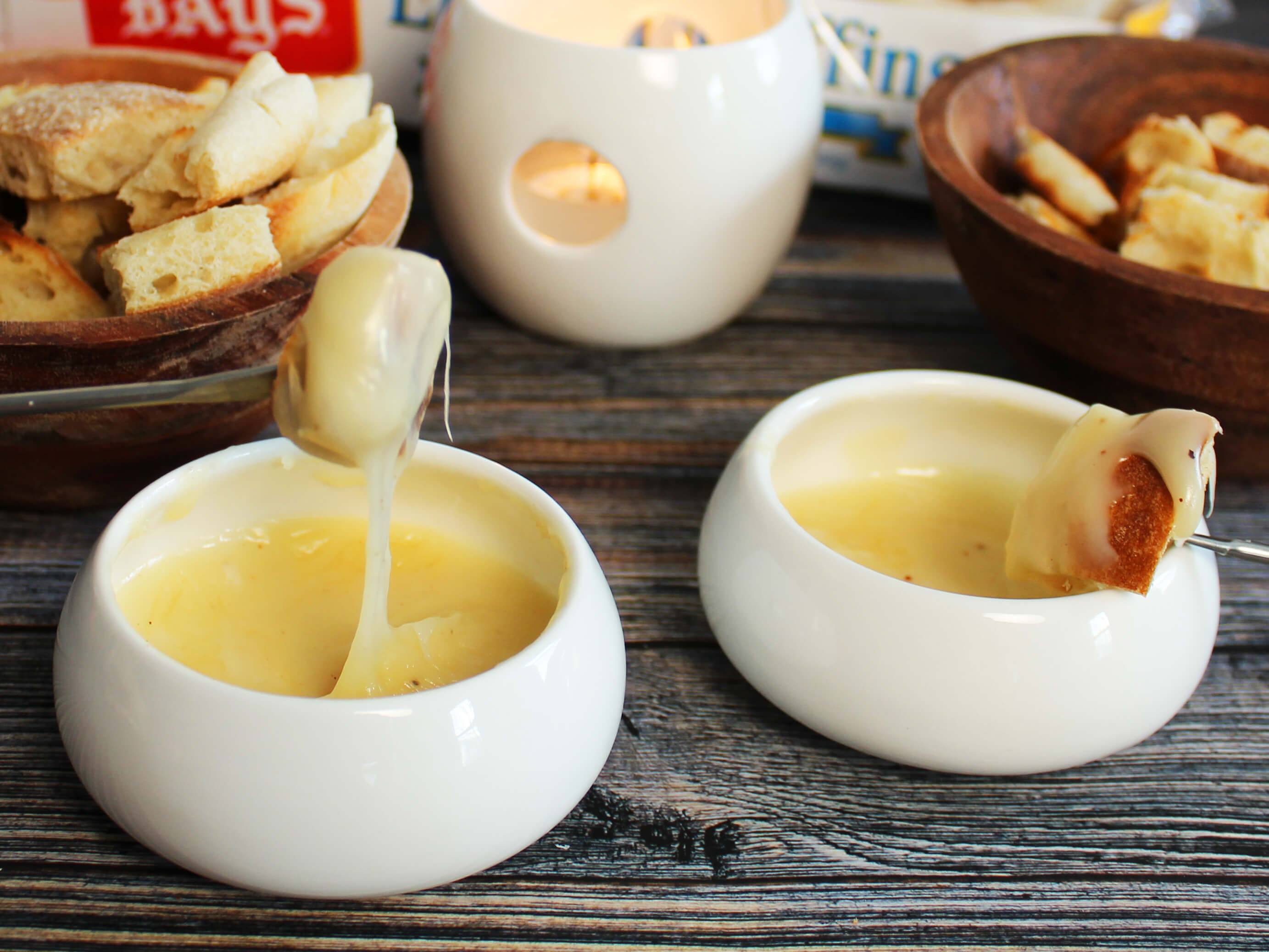 DISHES WITH MELTY DIP AND BAYS ON A LONG FORK