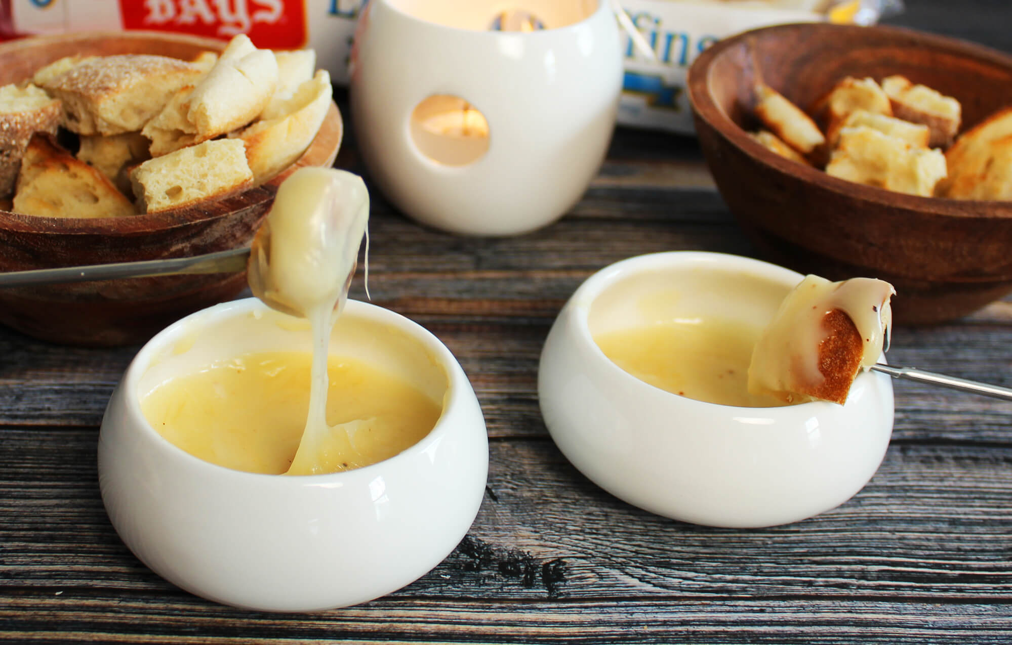 DISHES WITH MELTY DIP AND BAYS ON A LONG FORK