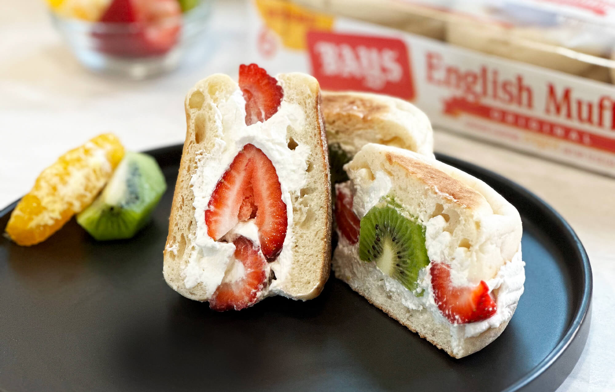 BAYS FILLED WITH WHIPPED CREAM AND SLICED STRAWBERRIES AND KIWI