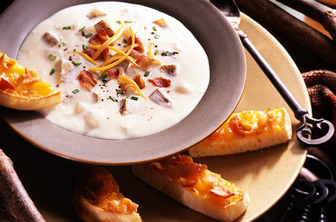 WHITE BISQUE NEXT TO SLICES OF BAYS TOPPED WITH CHEESE