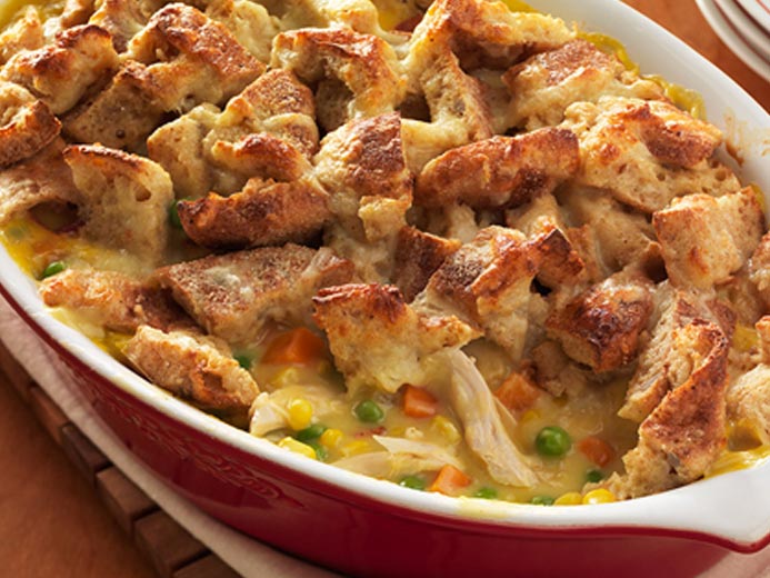 CASSEROLE DISH FILLED WITH WHITE MEAT, VEGGIES AND TOPPED WITH TOASTED BAYS ENGLISH MUFFINS