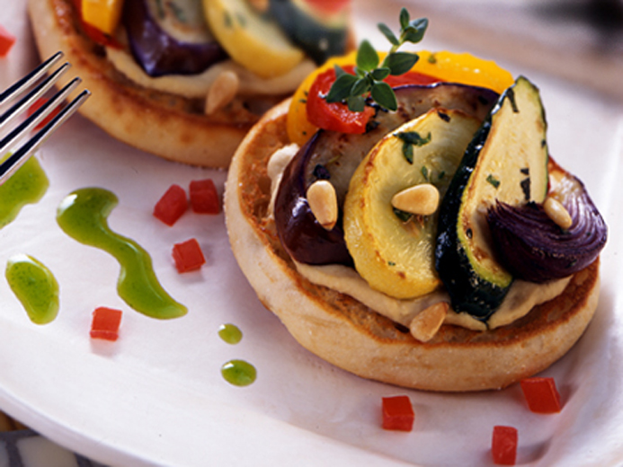 COOKED AND SLICED ZUCCHINI EGGPLANT AND SQUASH NEATLY PLACED ON TOASTED BAYS