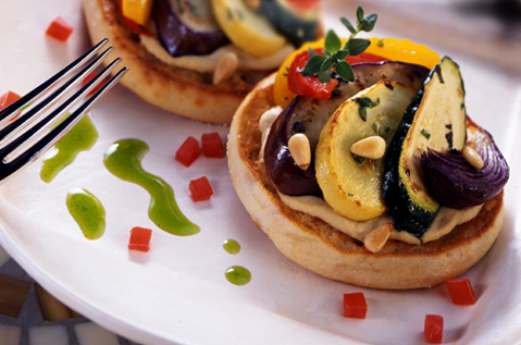 COOKED AND SLICED ZUCCHINI EGGPLANT AND SQUASH NEATLY PLACED ON TOASTED BAYS