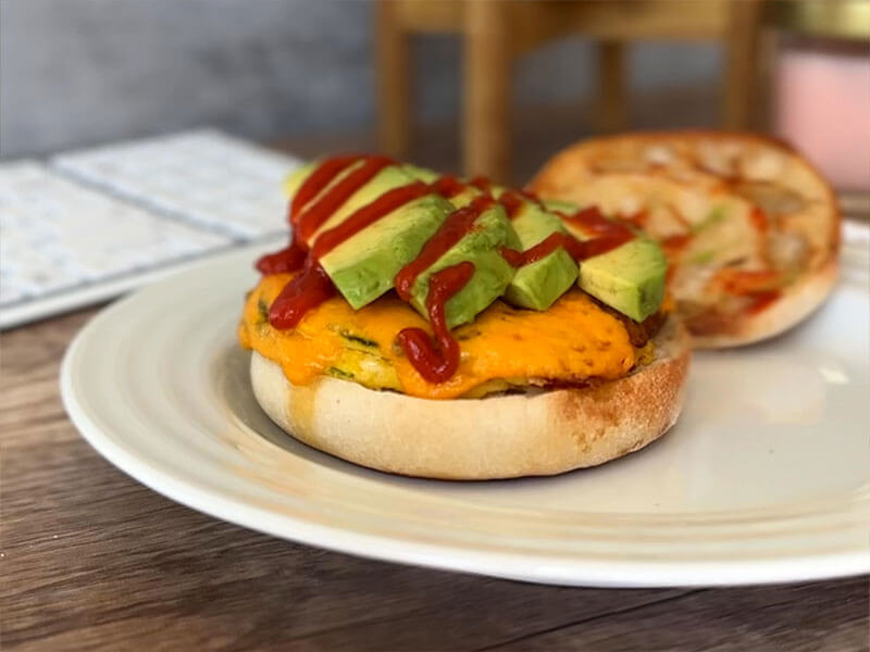 bays with melty cheese green veggie wedges and a hot sauce drizzle