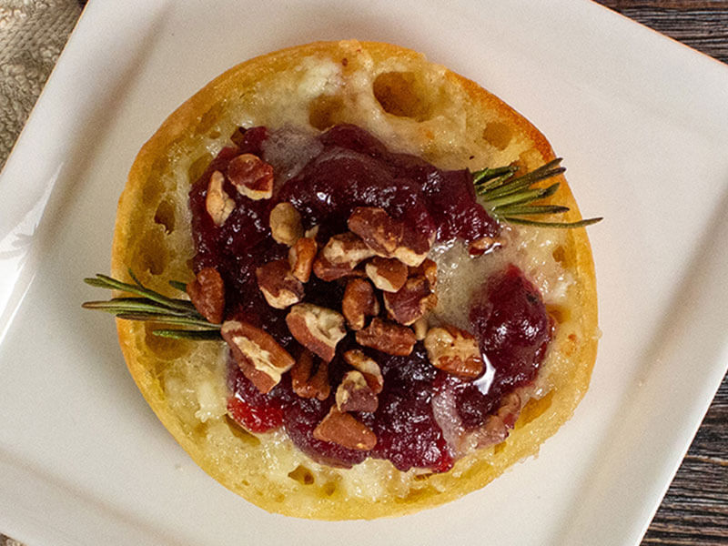 bays topped with a red fruit paste and nuts