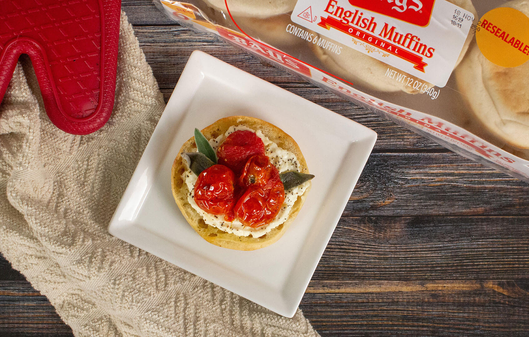 bays topped with white cream, red fruit and basil