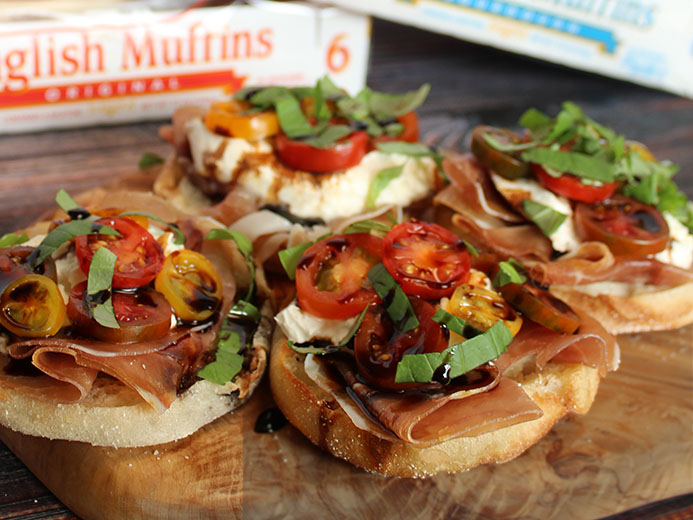 BAYS TOPPED WITH MEAT TOMATO LETTUCE AND DRIZZLE