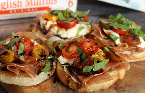 BAYS TOPPED WITH MEAT TOMATO LETTUCE AND DRIZZLE