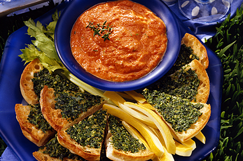 BAYS SLICED INTO WEDGES TOPPED WITH GREEN PASTE