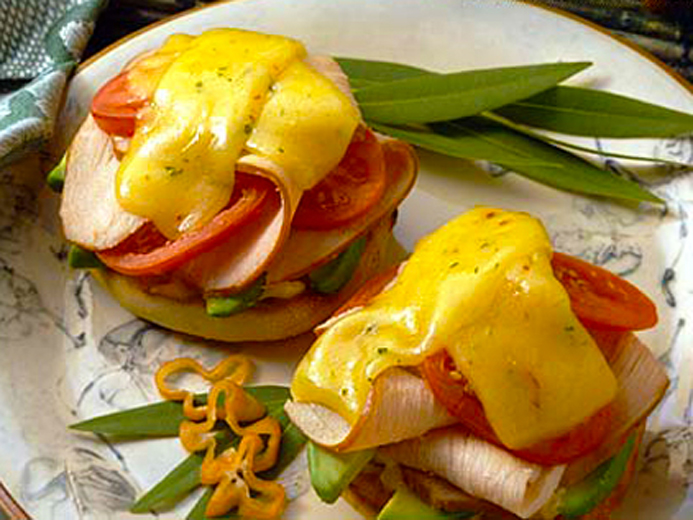 BAYS TOPPED WITH SLICED TURKEY TOMATOES AND MELTY CHEESE