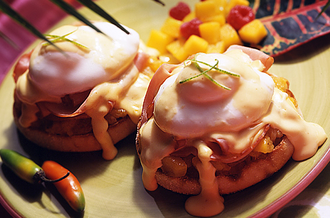 BAYS COVERED IN HAM, EGG, AND WHITE SAUCE NEXT TO HOT PEPPERS