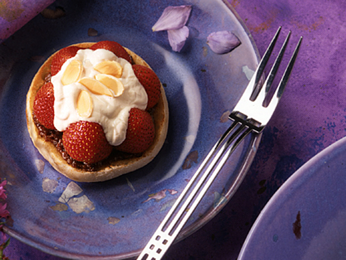 BAYS TOPPED WITH FRUIT AND CREAM ON A PURPLE PLATE
