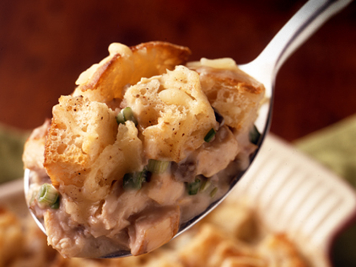A SPOON WITH BAYS MEAT AND VEGGIES ON IT
