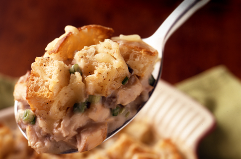 A SPOON WITH BAYS MEAT AND VEGGIES ON IT