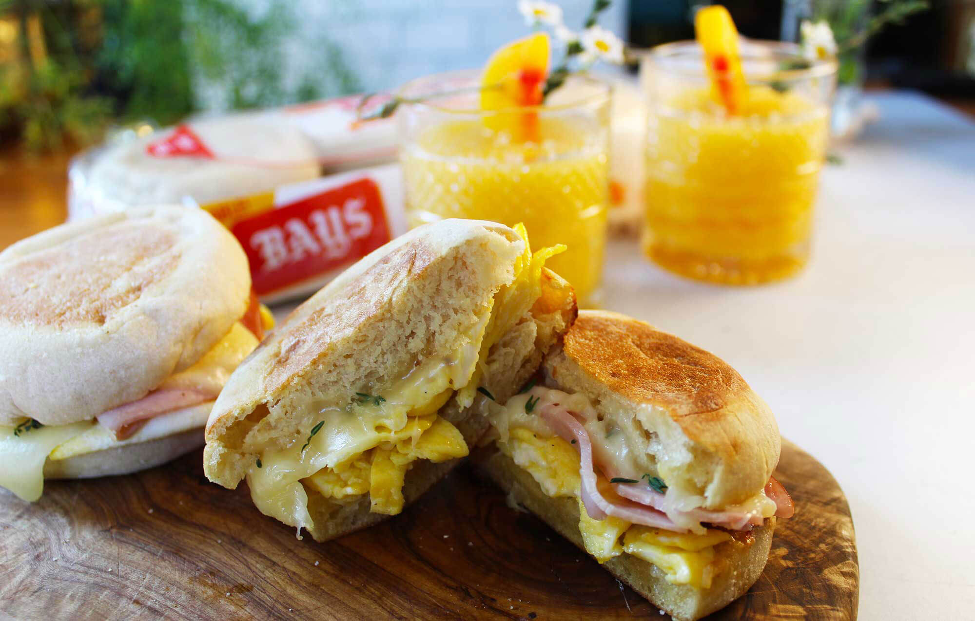 bays with meat cheese, and yellow drinks in the background