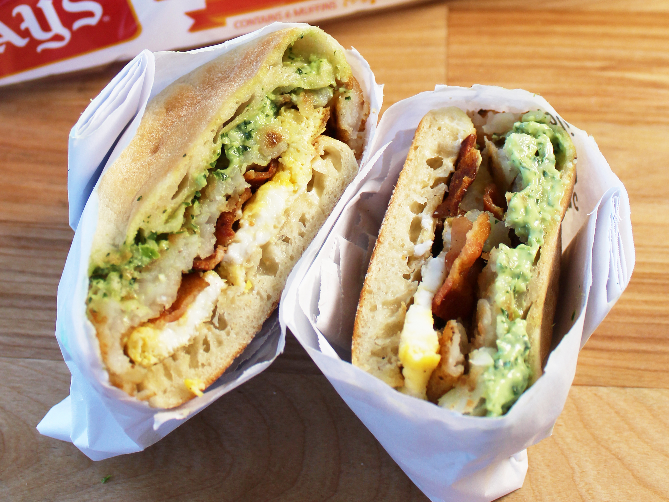 BAYS WITH BACON EGG AND AVOCADO WRAPPED IN PAPER