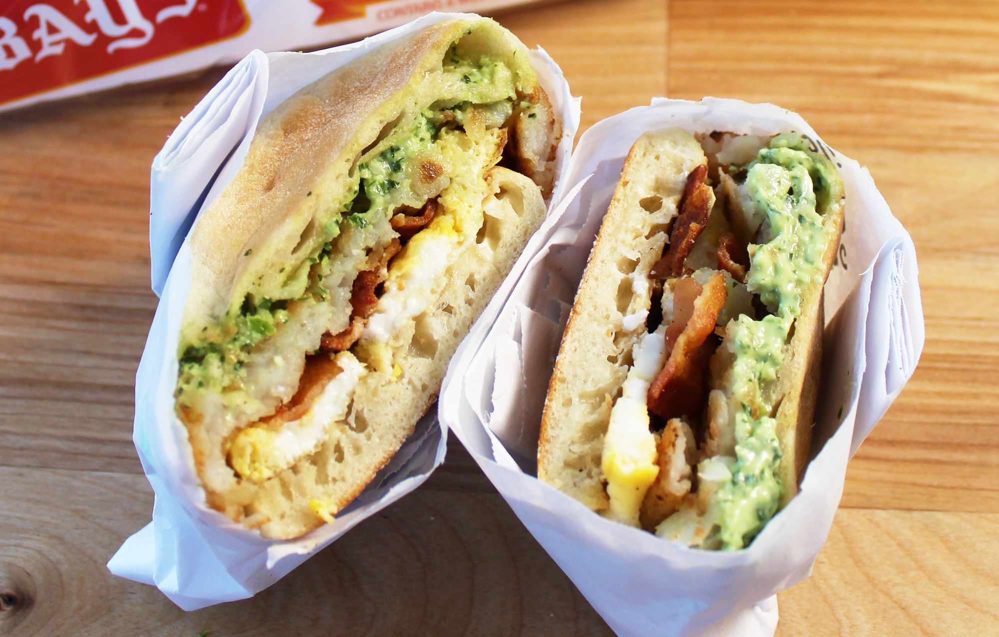 BAYS WITH BACON EGG AND AVOCADO WRAPPED IN PAPER