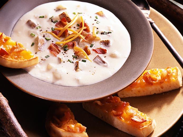 WHITE BISQUE NEXT TO SLICES OF BAYS TOPPED WITH CHEESE